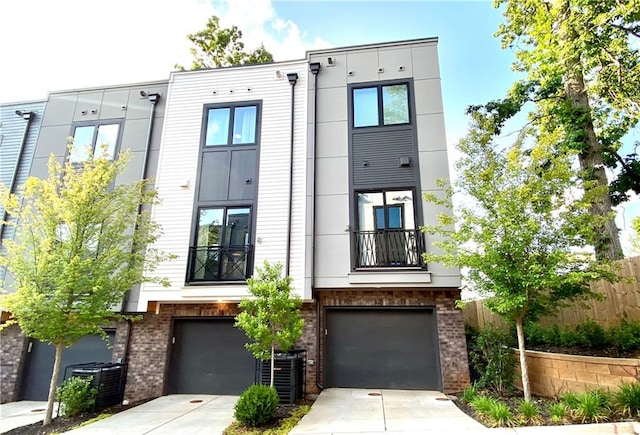 view of front of home with a garage and central AC unit