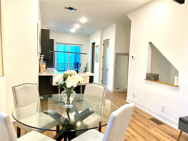 dining room with sink and light wood-type flooring