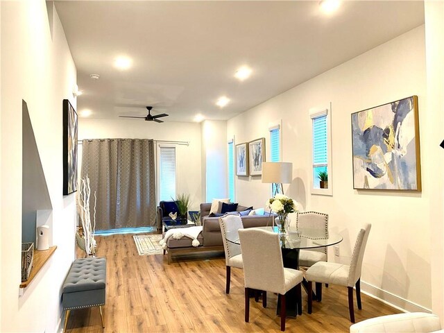 dining space with radiator, light hardwood / wood-style flooring, and ceiling fan