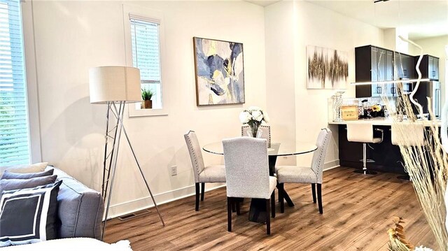 dining space with hardwood / wood-style flooring