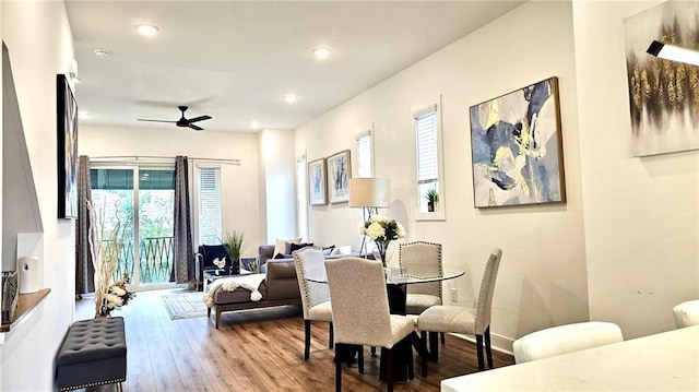 dining area with hardwood / wood-style flooring and ceiling fan