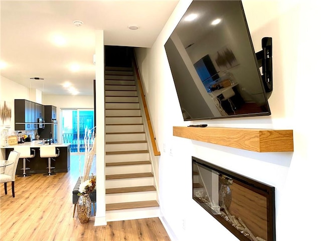 stairway with hardwood / wood-style floors