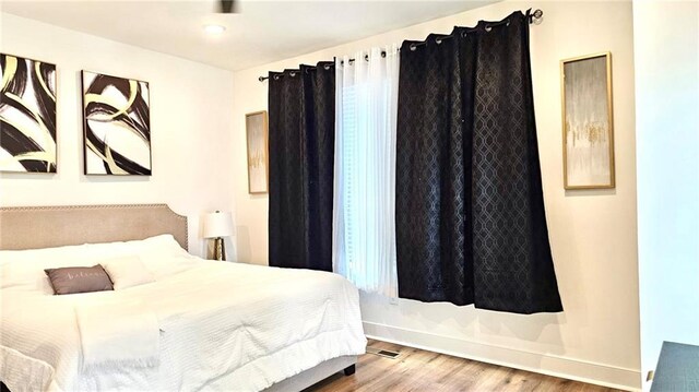 bedroom featuring hardwood / wood-style flooring