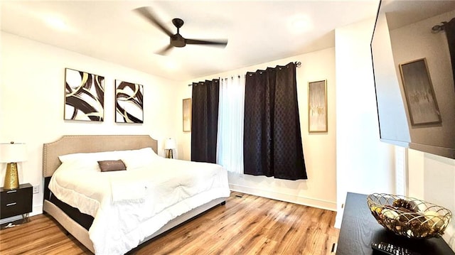 bedroom with ceiling fan and light wood-type flooring