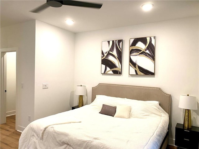 bedroom featuring hardwood / wood-style flooring and ceiling fan