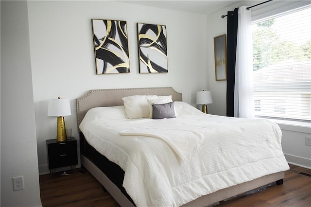 bedroom featuring dark hardwood / wood-style flooring