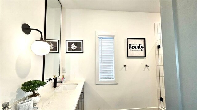 bathroom with vanity and a shower with door