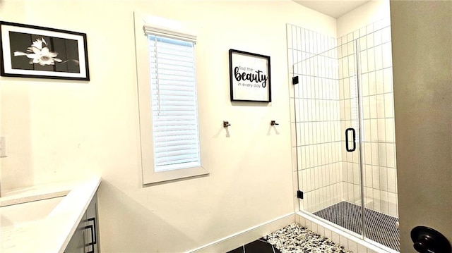 bathroom with vanity and a shower with shower door