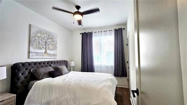 bedroom with ceiling fan and dark hardwood / wood-style flooring