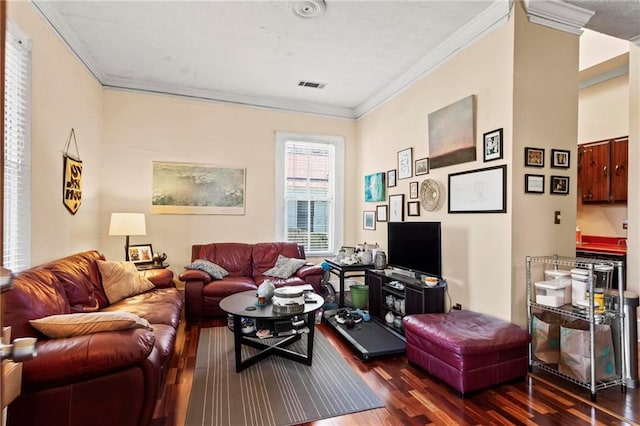 living area with crown molding, dark wood-style floors, and visible vents