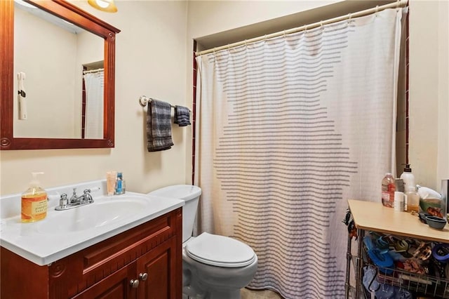 bathroom featuring toilet and vanity