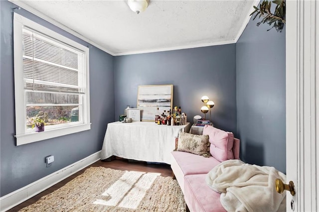 bedroom featuring baseboards, a textured ceiling, ornamental molding, and dark wood-style flooring