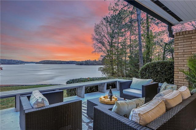 exterior space with a water view and an outdoor living space