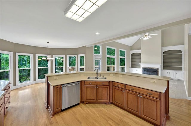 4910 Aldbury Ln, Suwanee, GA 30024 - kitchen featuring dishwasher, a sink, brown cabinetry, light wood-style floors, and lofted ceiling