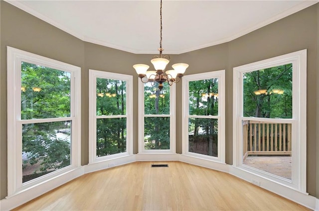 4910 Aldbury Ln, Suwanee, GA 30024 - unfurnished sunroom featuring a chandelier, wood finished floors, plenty of natural light, and ornamental molding