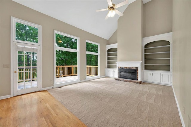 4910 Aldbury Ln, Suwanee, GA 30024 - unfurnished living room with baseboards, a fireplace, plenty of natural light, ceiling fan, and high vaulted ceiling