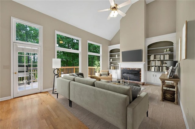 4910 Aldbury Ln, Suwanee, GA 30024 - living area featuring high vaulted ceiling, a glass covered fireplace, plenty of natural light, ceiling fan, and baseboards