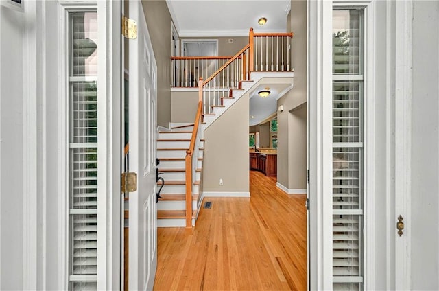 4910 Aldbury Ln, Suwanee, GA 30024 - foyer entrance featuring wood finished floors, baseboards, stairs, and crown molding