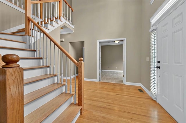 4910 Aldbury Ln, Suwanee, GA 30024 - foyer with wood finished floors, stairs, a high ceiling, and baseboards
