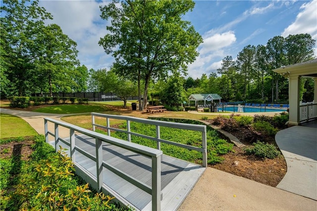4910 Aldbury Ln, Suwanee, GA 30024 - surrounding community featuring a pool and view of scattered trees