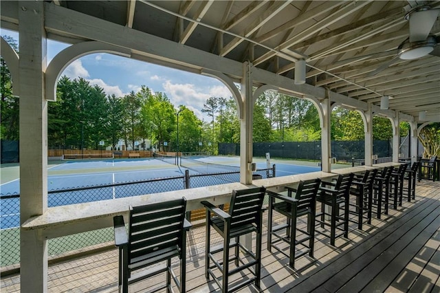 4910 Aldbury Ln, Suwanee, GA 30024 - wooden terrace featuring a tennis court, a ceiling fan, and view of scattered trees