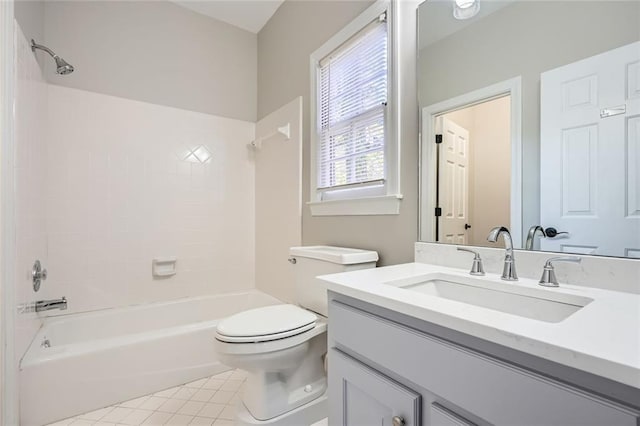 full bathroom with tile patterned flooring, tiled shower / bath, vanity, and toilet