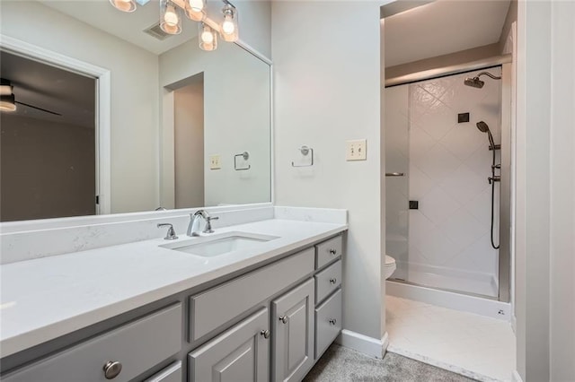 bathroom featuring vanity, toilet, and a shower with shower door