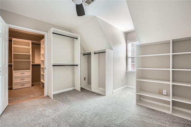 spacious closet featuring vaulted ceiling, ceiling fan, and carpet