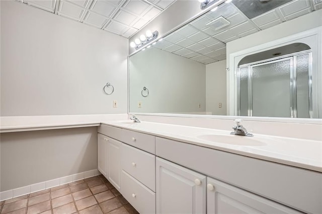 bathroom with vanity, an enclosed shower, and tile patterned floors