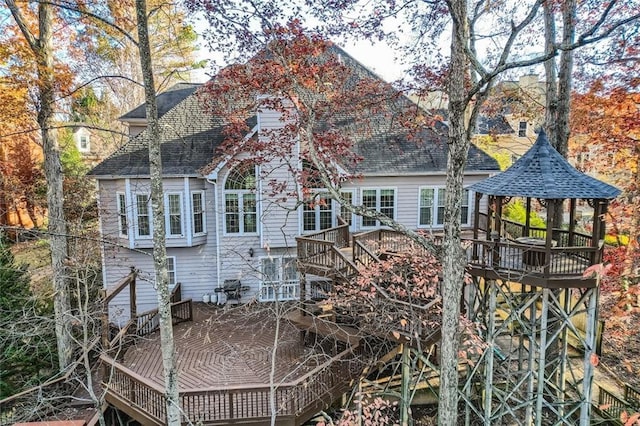 rear view of property with a gazebo and a deck