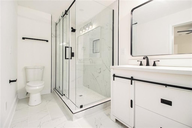 bathroom with vanity, a shower with shower door, and toilet