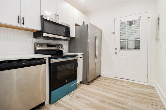 kitchen featuring backsplash, stainless steel appliances, light hardwood / wood-style floors, and white cabinets