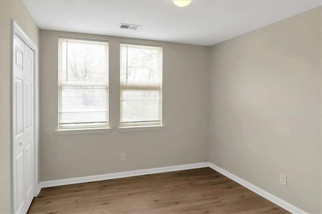 unfurnished room featuring dark wood-type flooring