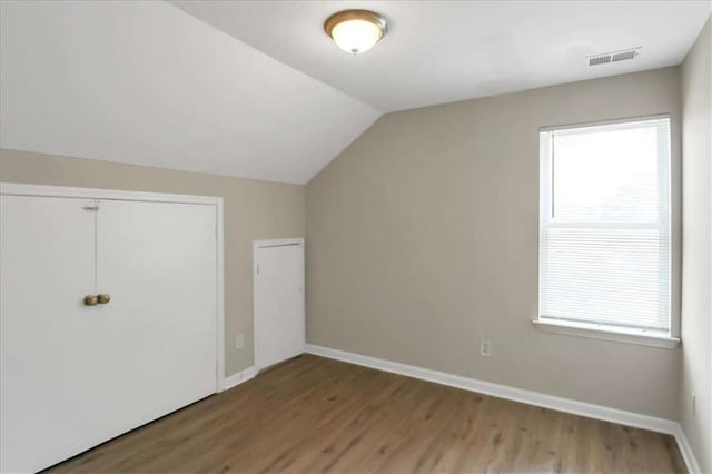 bonus room featuring vaulted ceiling and wood-type flooring