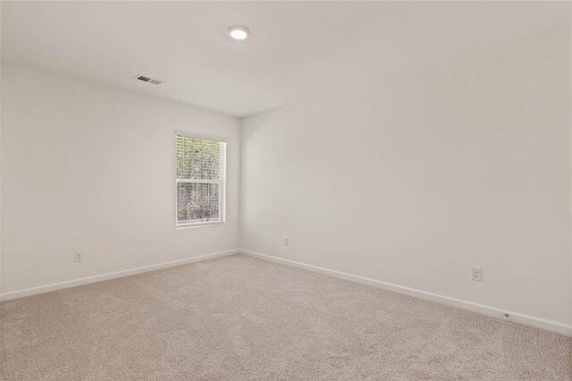 12086 Conrad Cir, Hampton, GA 30228 - carpeted empty room with baseboards