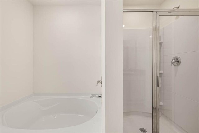 12086 Conrad Cir, Hampton, GA 30228 - full bathroom featuring a stall shower and a garden tub