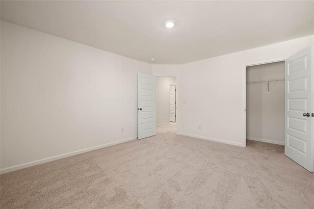 12086 Conrad Cir, Hampton, GA 30228 - unfurnished bedroom featuring light colored carpet, baseboards, and a closet