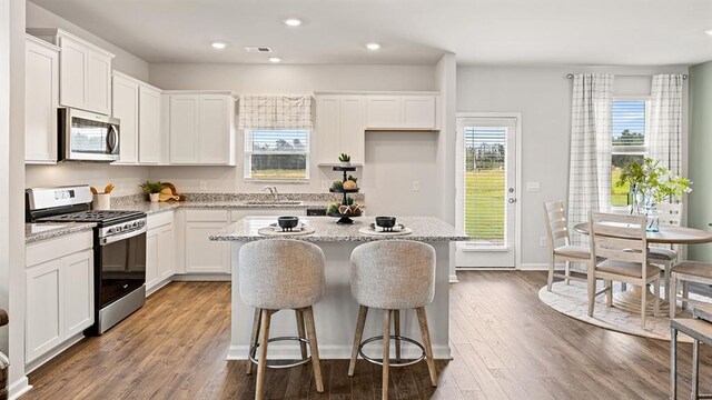 12086 Conrad Cir, Hampton, GA 30228 - kitchen featuring appliances with stainless steel finishes, a sink, a center island, white cabinetry, and recessed lighting