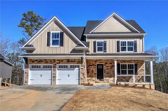 craftsman-style home featuring covered porch, concrete driveway, an attached garage, board and batten siding, and stone siding