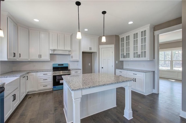 kitchen featuring dark wood-type flooring, glass insert cabinets, stainless steel electric range, and white cabinetry