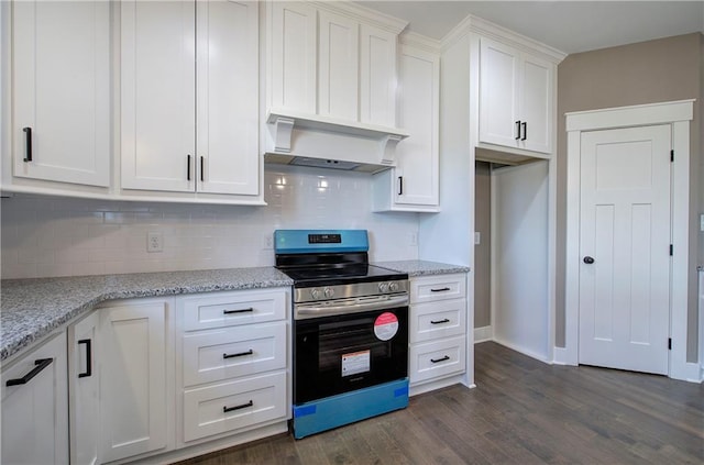 kitchen with decorative backsplash, white cabinets, wall chimney exhaust hood, stainless steel electric range oven, and dark wood-style flooring