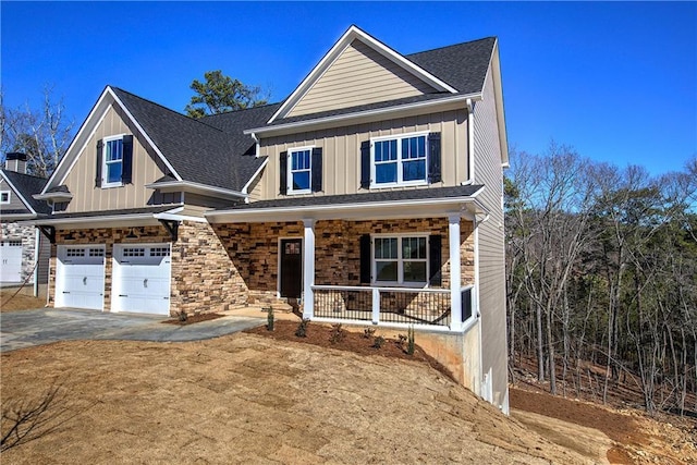 view of front facade with board and batten siding, covered porch, driveway, and a garage