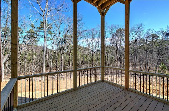 wooden deck featuring a wooded view