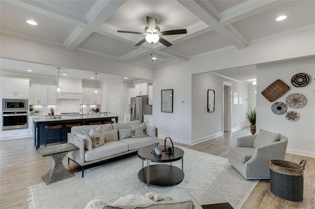 living room with coffered ceiling, light hardwood / wood-style flooring, and beamed ceiling