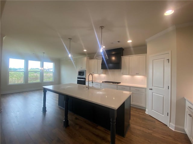 226 Montview Dr, Jefferson, GA 30549 - kitchen featuring a sink, custom range hood, stainless steel appliances, a kitchen island with sink, and baseboards