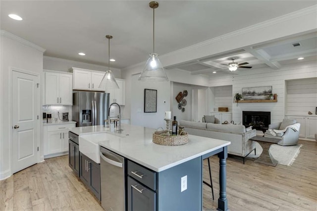 kitchen featuring coffered ceiling, beamed ceiling, white cabinets, and appliances with stainless steel finishes