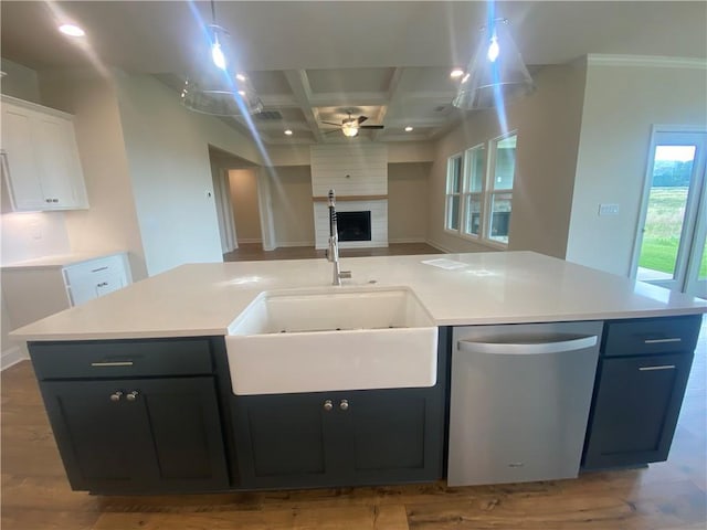226 Montview Dr, Jefferson, GA 30549 - kitchen featuring stainless steel dishwasher, ceiling fan, a sink, a large fireplace, and coffered ceiling