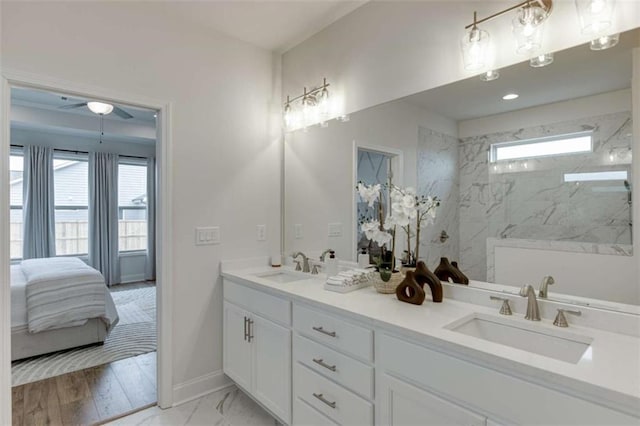 bathroom with vanity and a tile shower