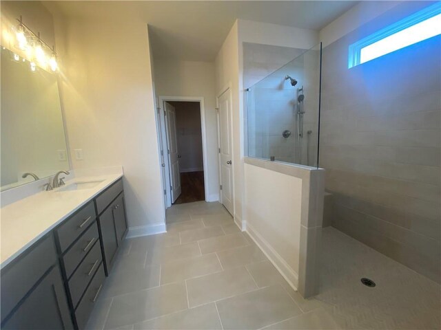 226 Montview Dr, Jefferson, GA 30549 - bathroom featuring a walk in shower, tile patterned flooring, vanity, baseboards, and a spacious closet