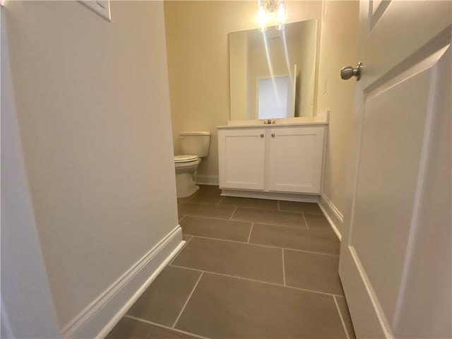 226 Montview Dr, Jefferson, GA 30549 - half bath with tile patterned flooring, toilet, vanity, and baseboards